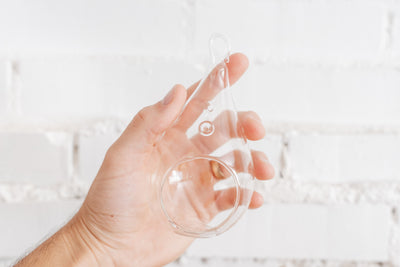 Hand Holding Teardrop Shaped Glass Terrarium